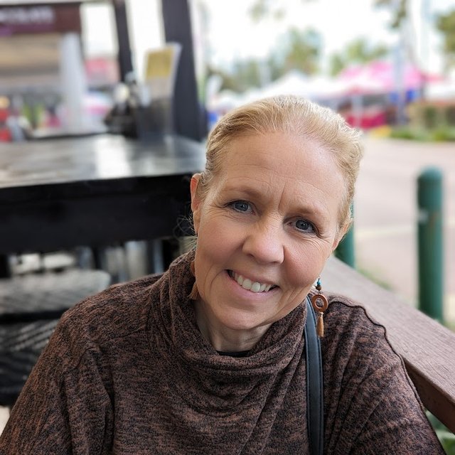 Ruth, founder of RumiFit, smiling at an outdoor café table